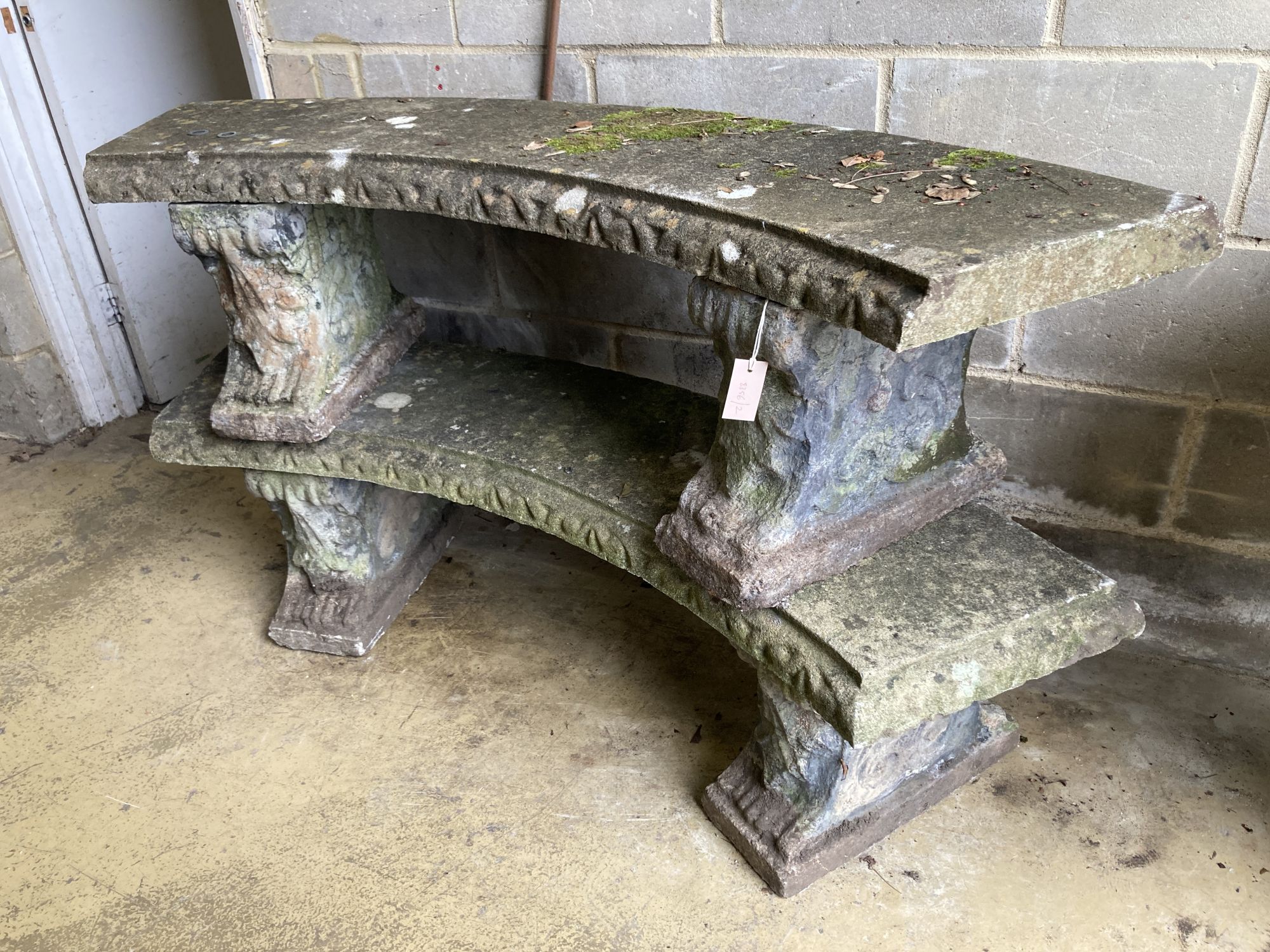 A pair of reconstituted stone curved garden bench seats, length 160cm, width 40cm, height 42cm